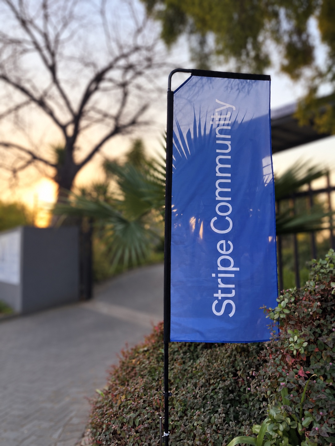 Stripe Community branded outdoor flag at an event